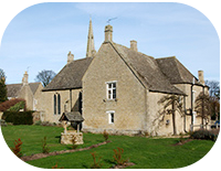 13th century Prebendal Manor in Peterborough surrounded by a lush green yard, which features a well in the middle. 