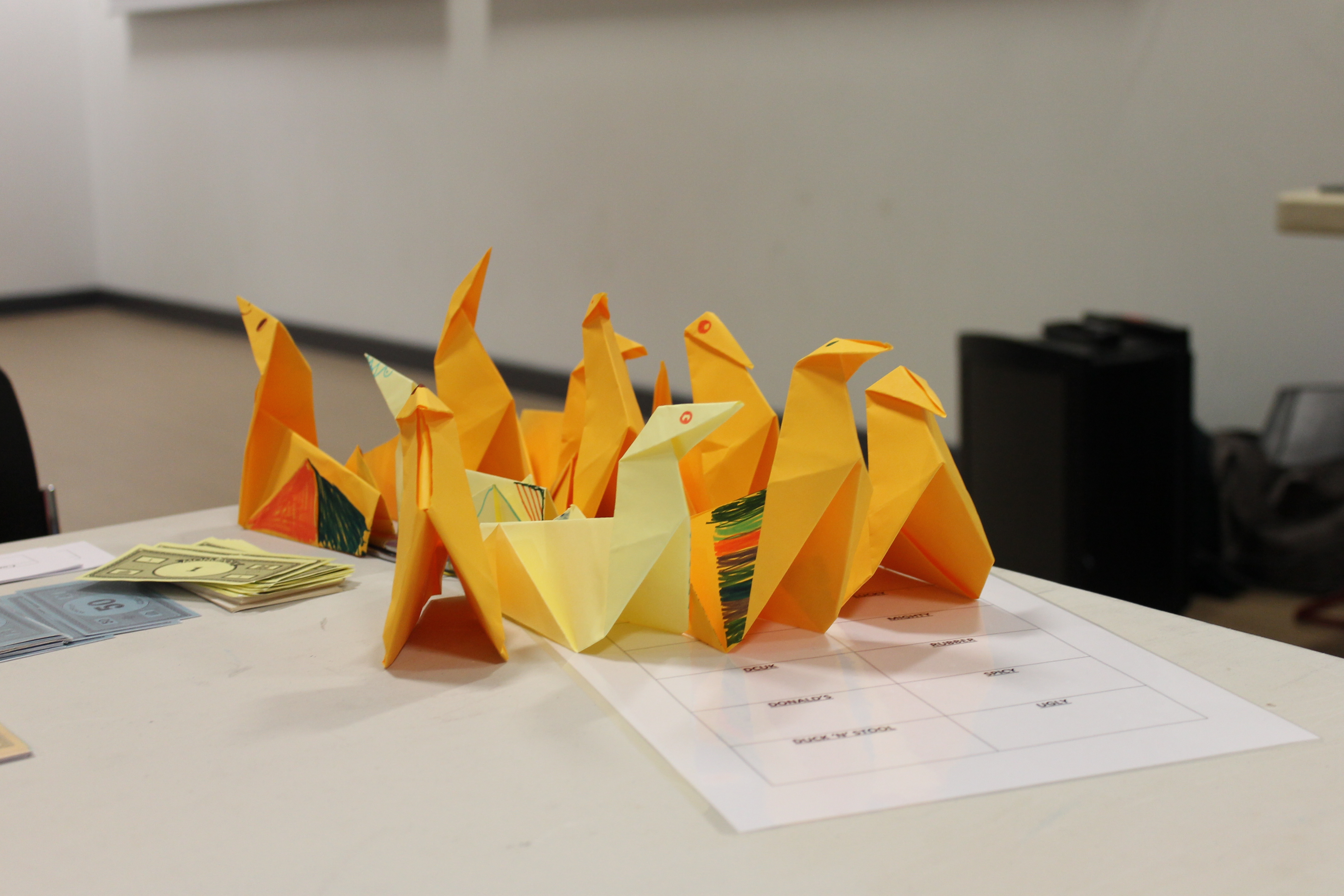 How does making paper ducks inspire students about business?